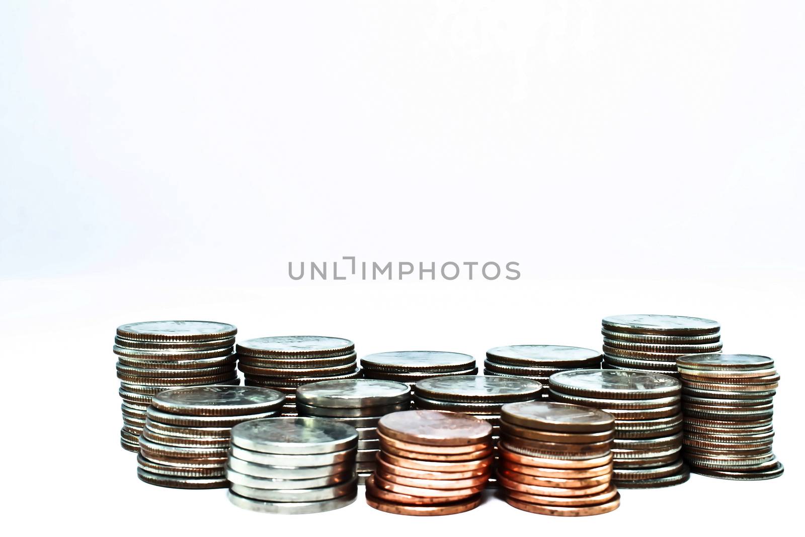 Thirteen stacks of coins ranging from pennies to quarter varying heights. Majority are quarters.