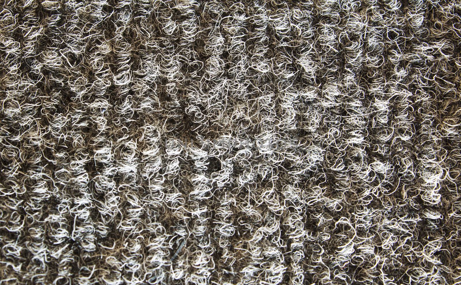 Closeup shot of rough looking gray carpet.