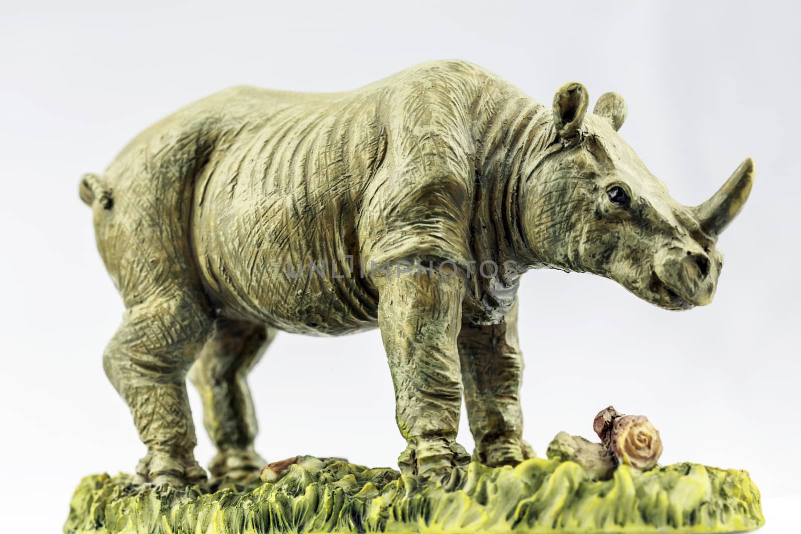 Figurine of a white rhino with white background.