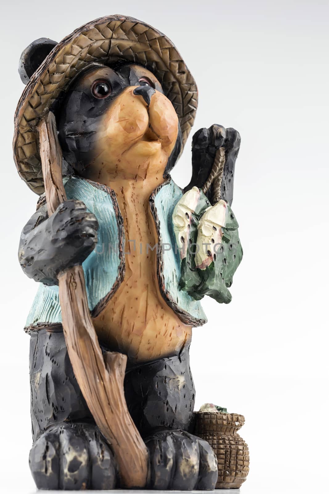 Charming bear statue with fishing theme. 