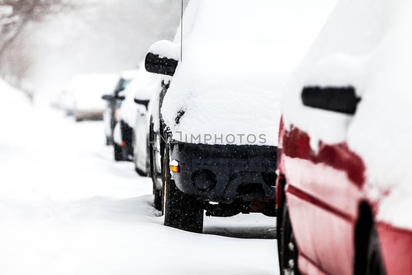 Parked Cars in the Street on a Snowstorm Winter Day