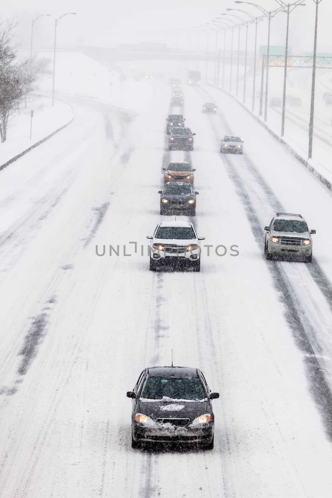 Lined up Cars on the Highway on a Snowstorm Winter day