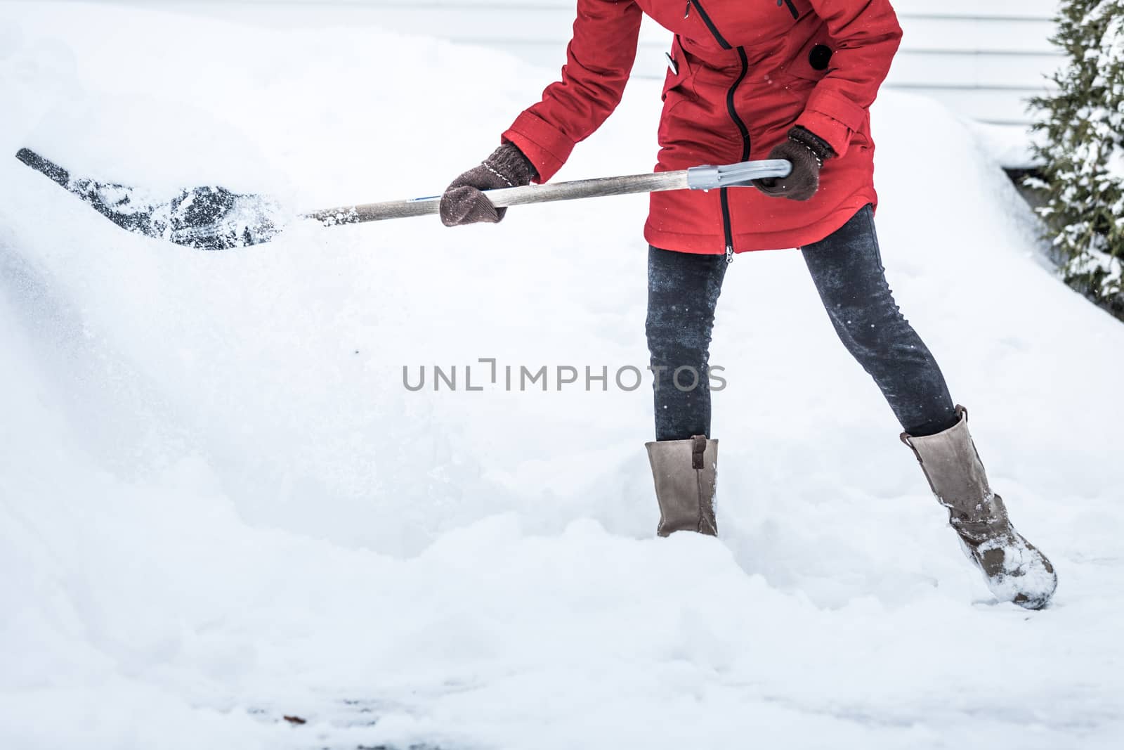 Close-up of Woman Shoveling her Parking lot after Snowstorm