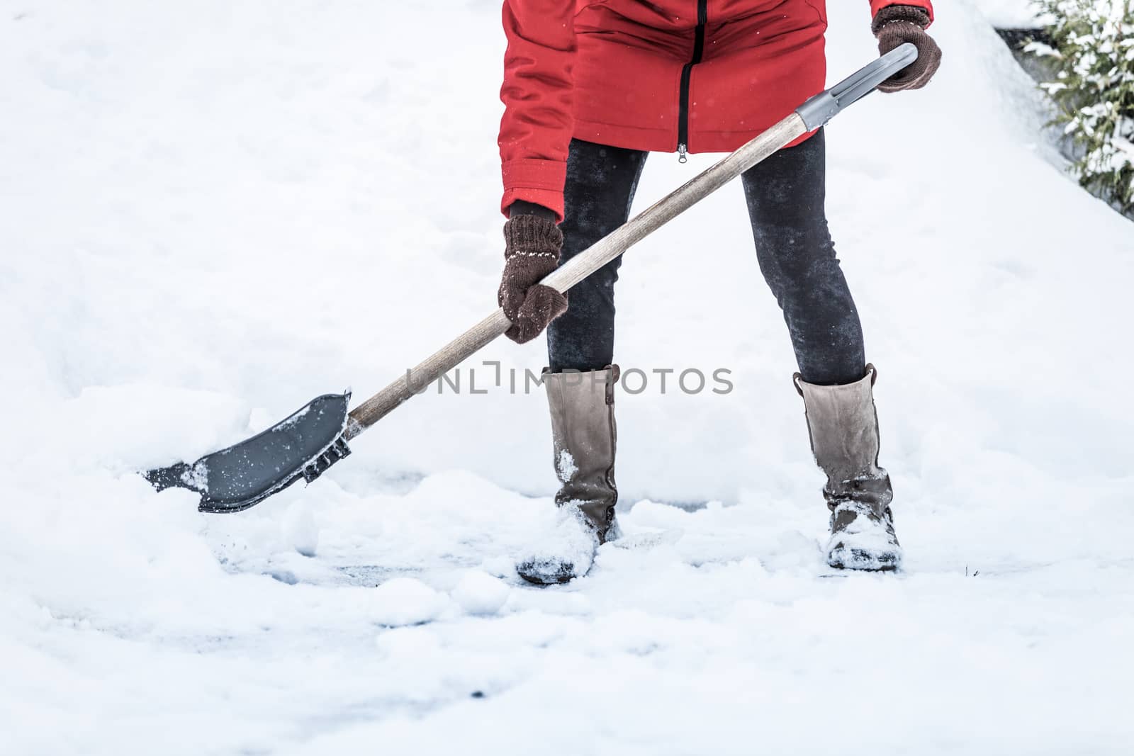 Close-up of Woman Shoveling her Parking lot after Snowstorm