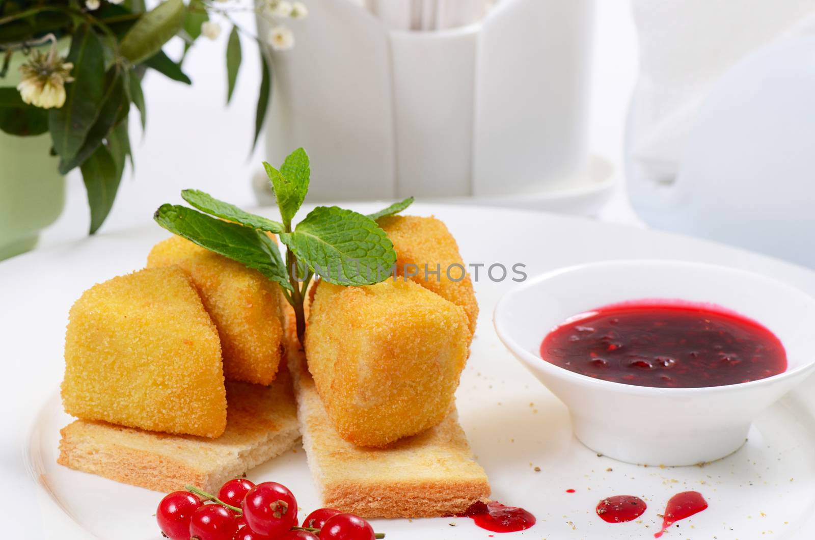 The cheese in breadcrumbs with currant jam