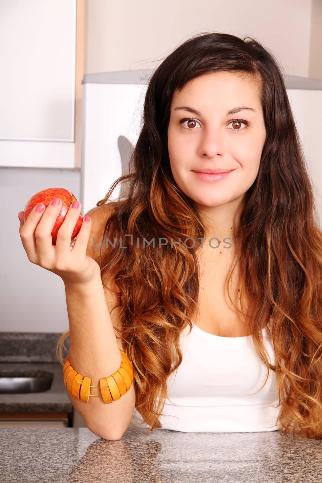 A young adult woman holding a Apple.