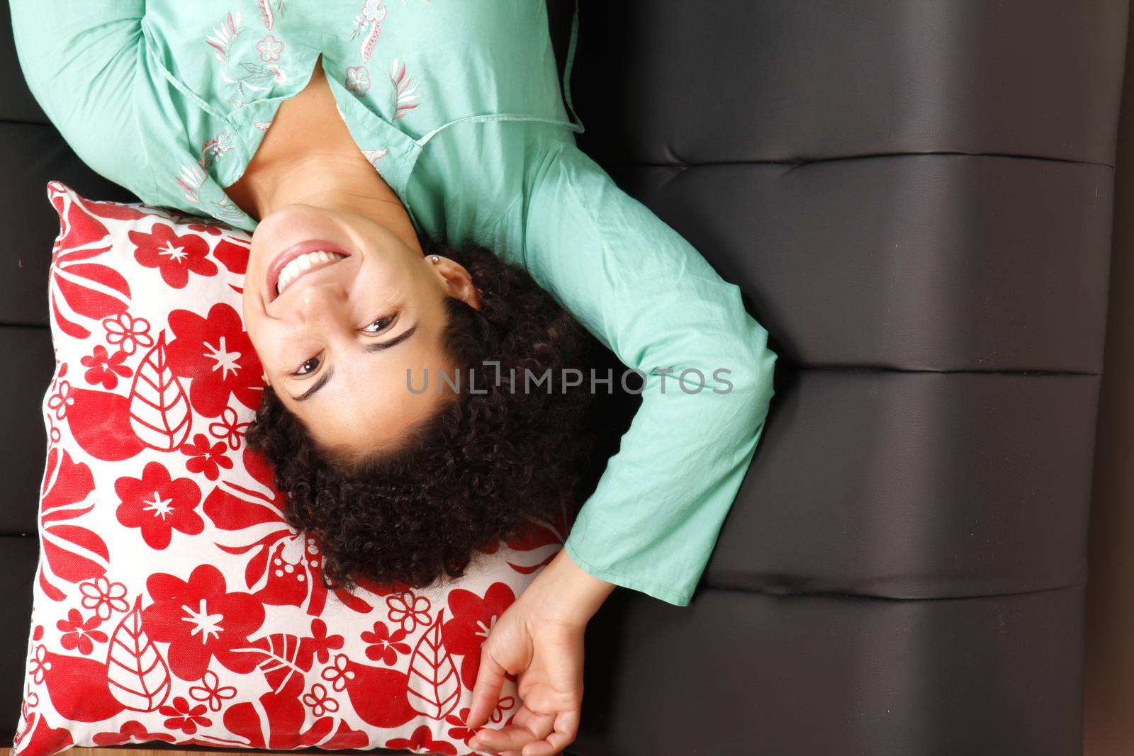 A jung brazilian woman relaxing on the sofa.