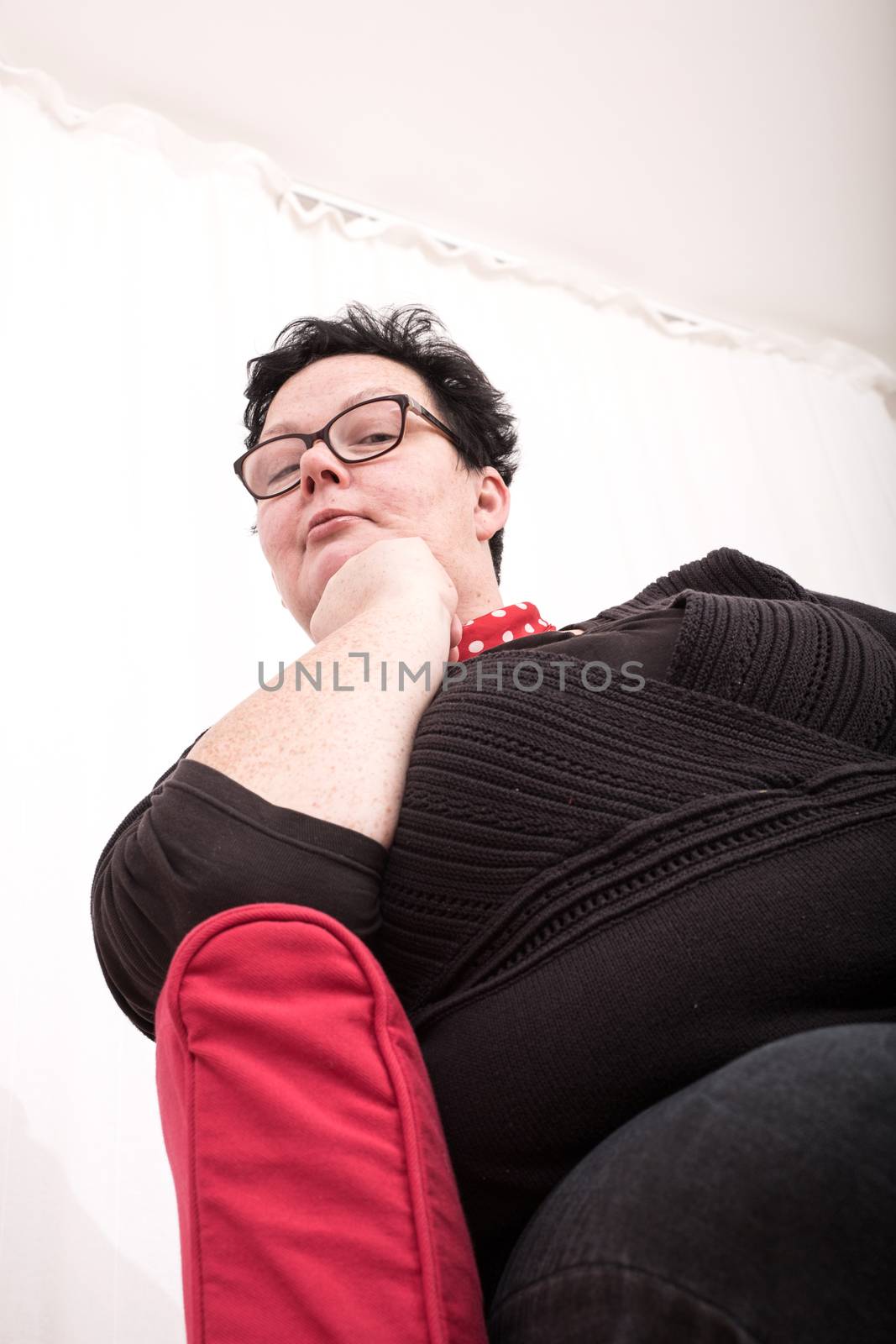 A relaxed woman sitting in the living room.