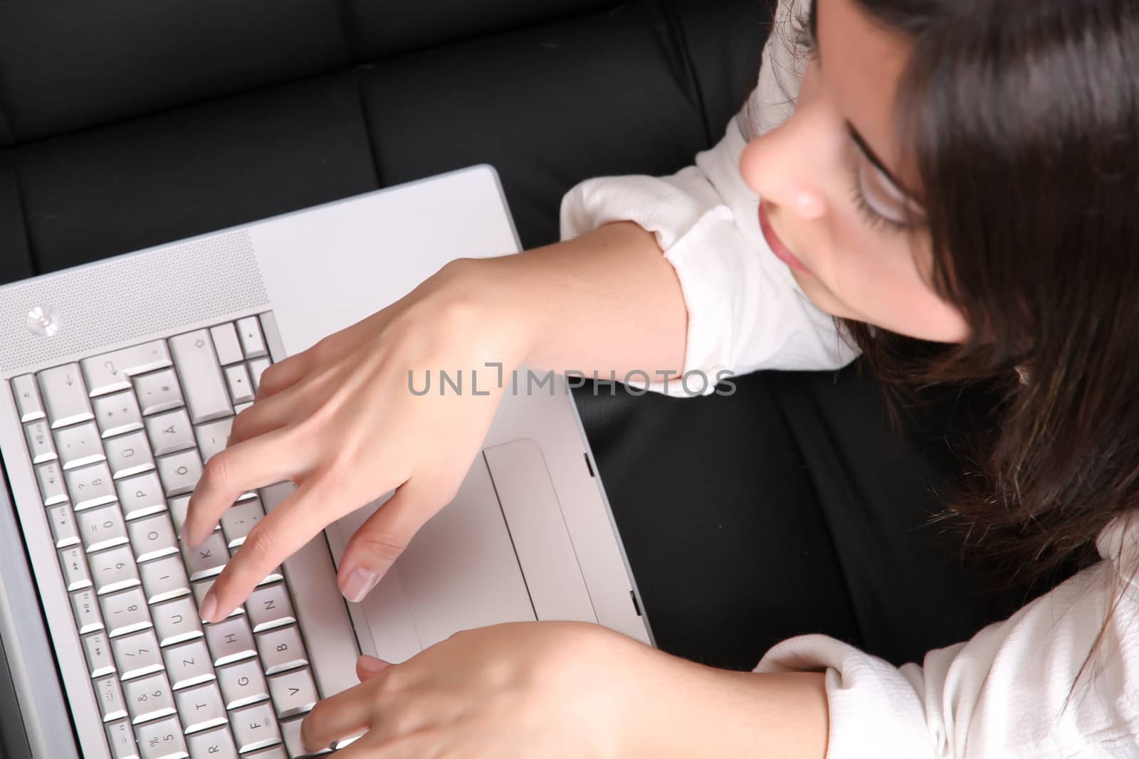 Young Hispanic Woman surfing on the Sofa by Spectral