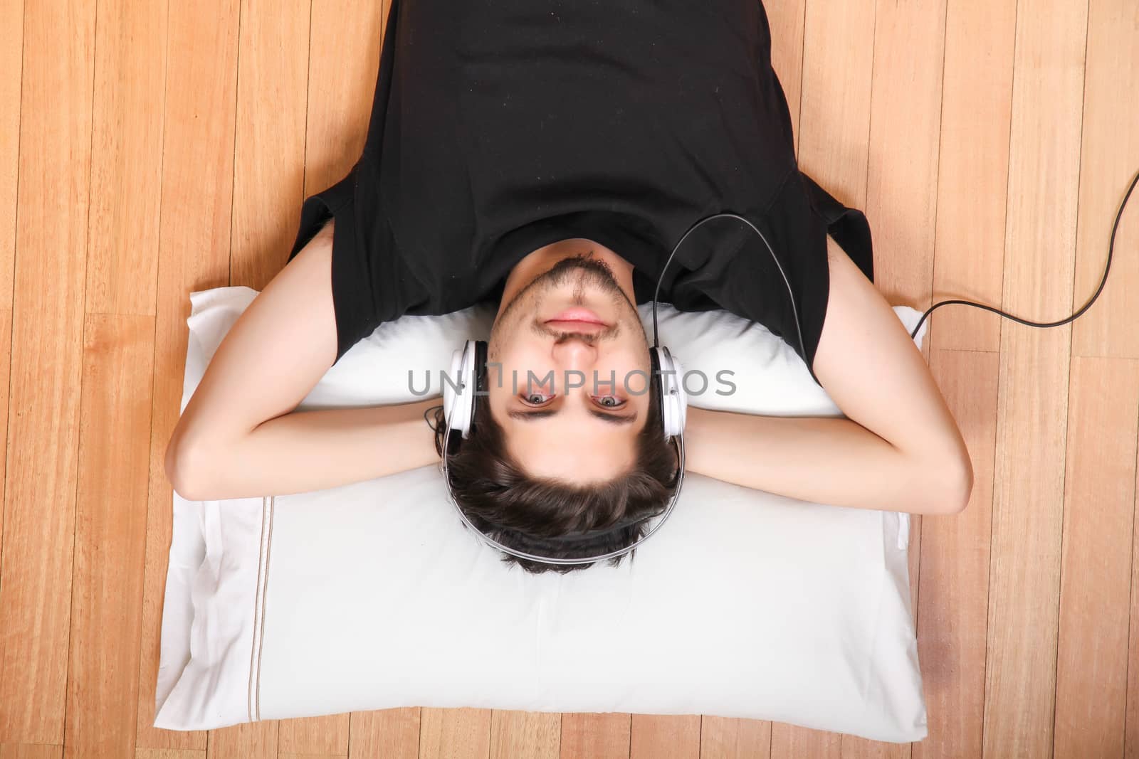 A young hispanic man listening Music with headphones.