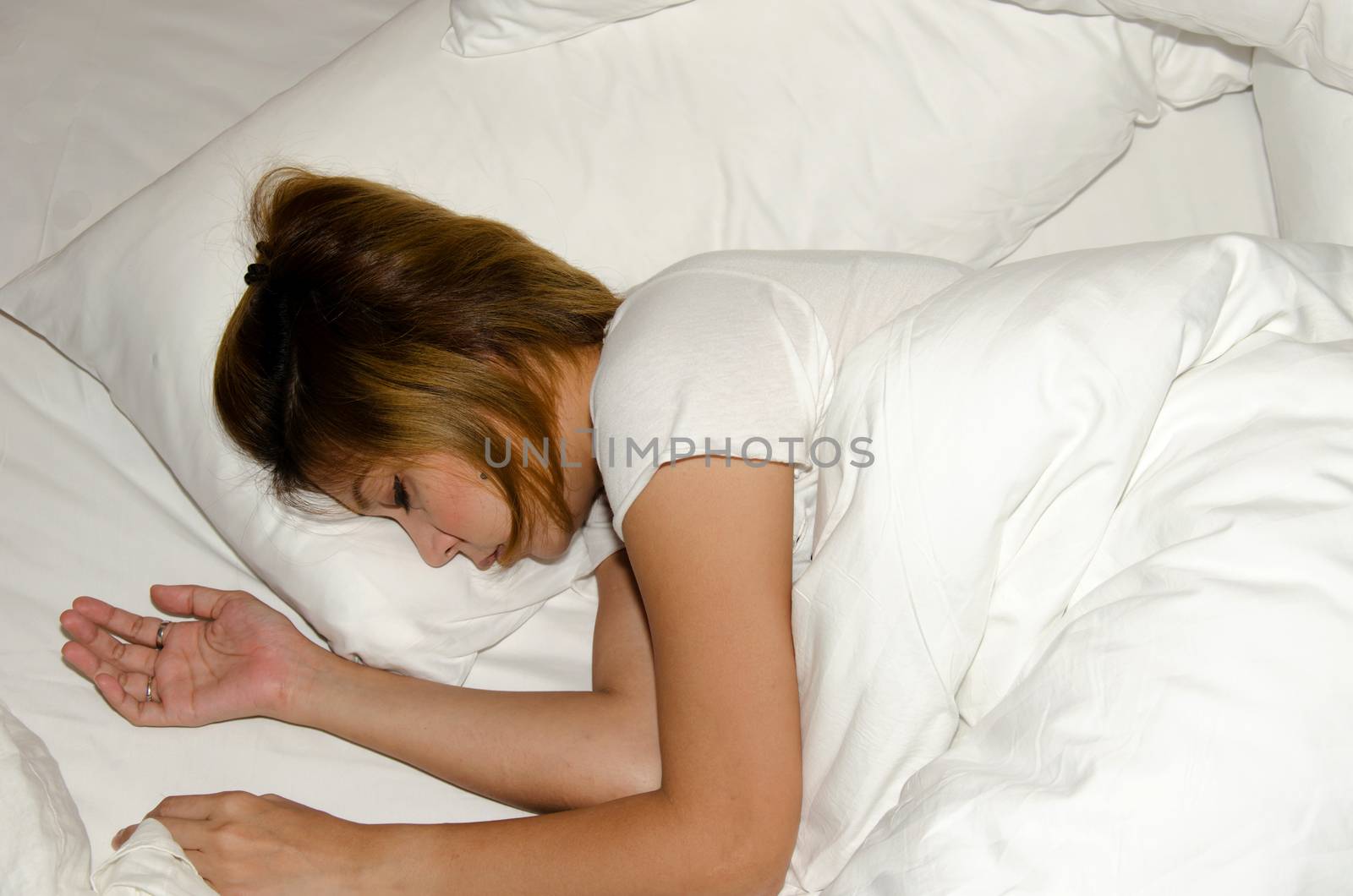 Of Asia woman sleeping on white bed.