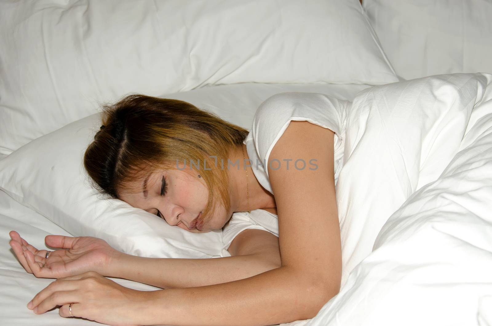 Of Asia woman sleeping on white bed.