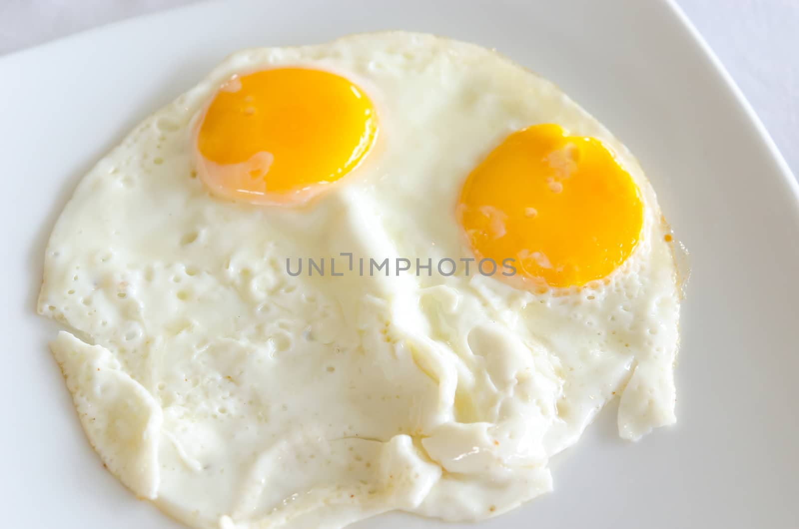 Two fried eggs placed in the dish.