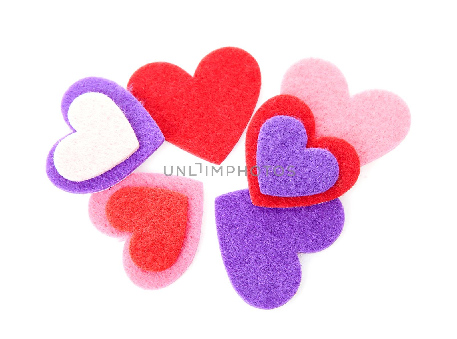 Couple of hearts made of felt over white background