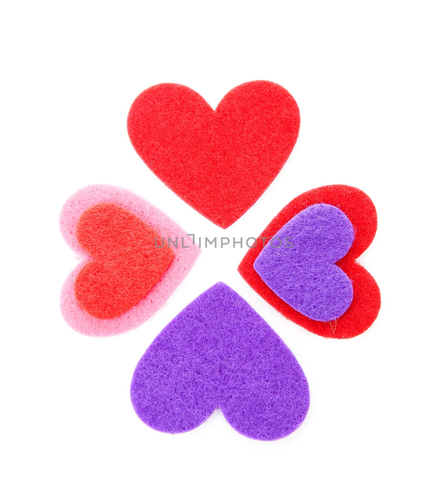 Four hearts made of felt over white background