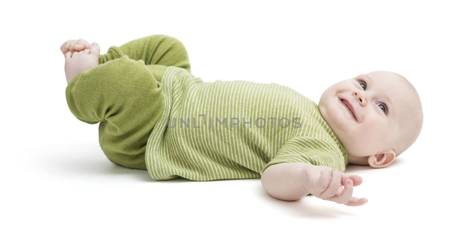 happy toddler lying on his back in green clothing by gewoldi