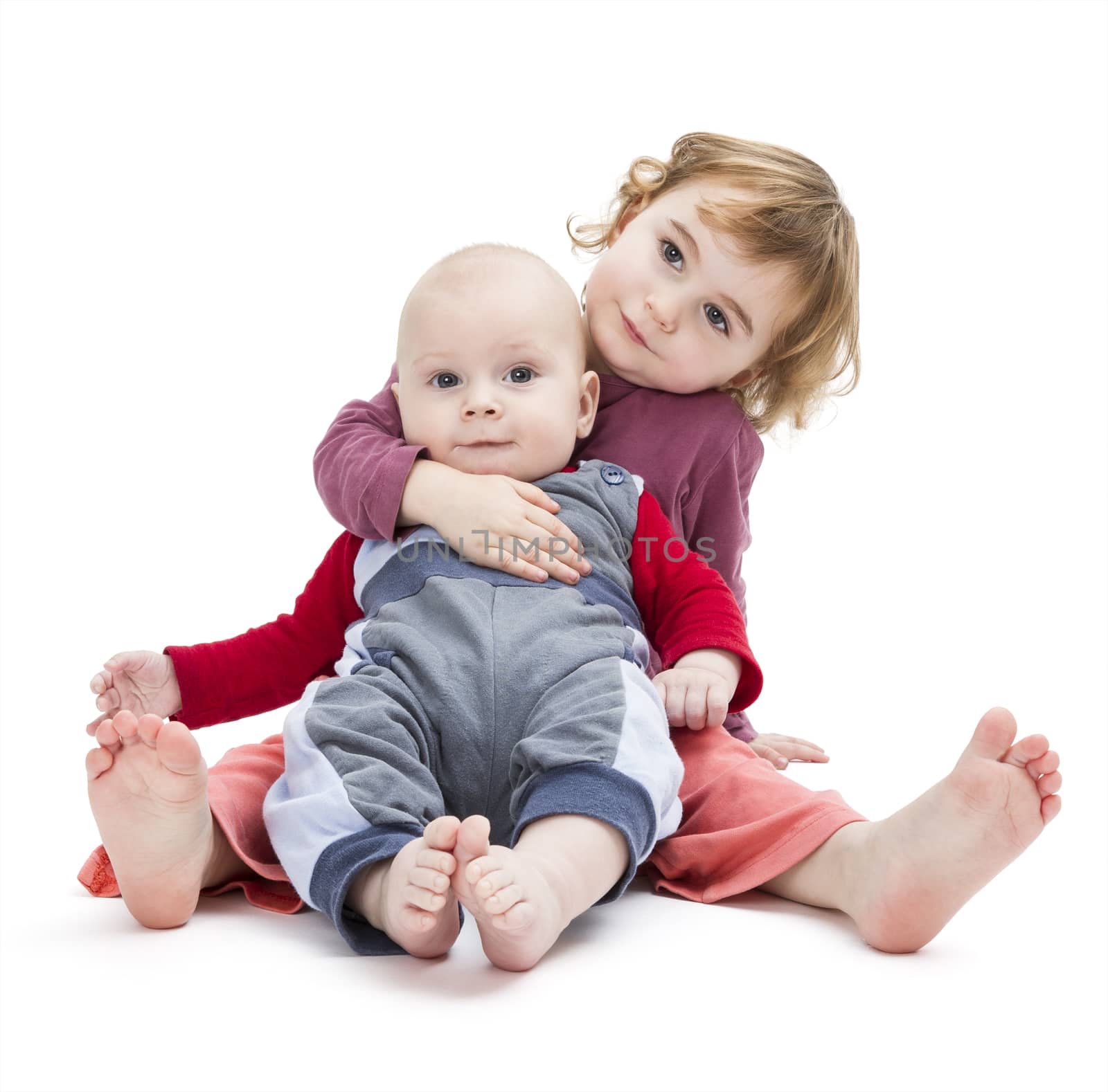 boy and girl sitting on floor. isolated on white background