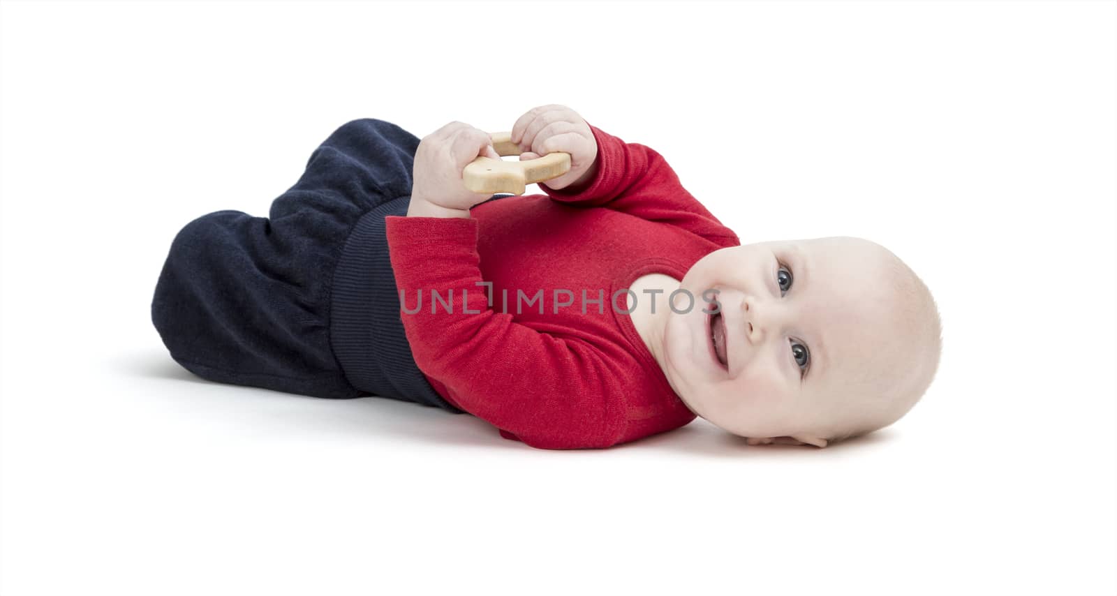 happy baby in red shirt on floor. isolated on white background. studio shot