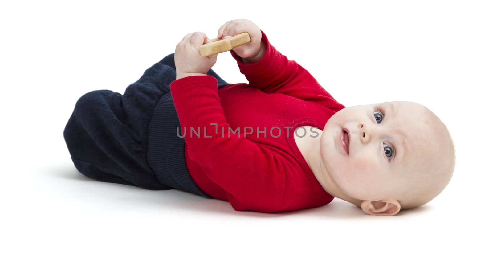 happy baby in red shirt on floor. isolated on white background. studio shot
