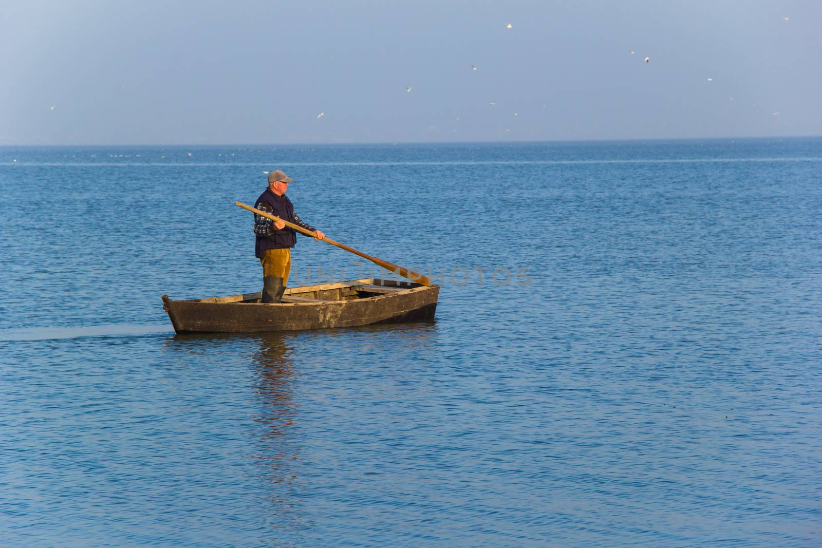 fisherman in boat on water
