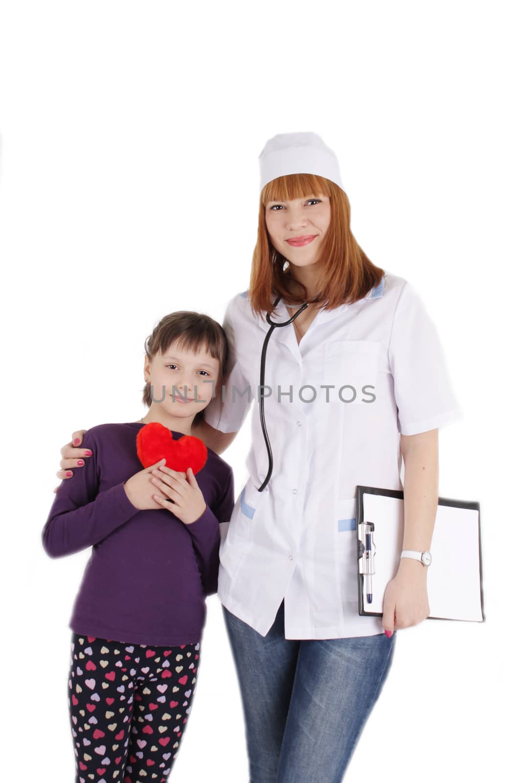 Smiling female doctor and little girl holding plush heart over white