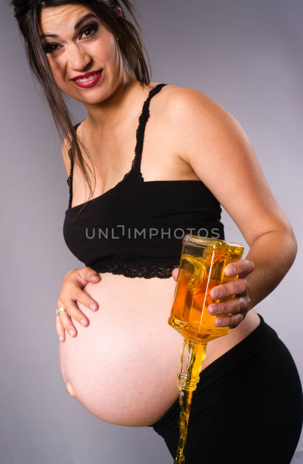Pregnant Woman Expecting Baby Pours Alcohol Empties Whiskey by ChrisBoswell