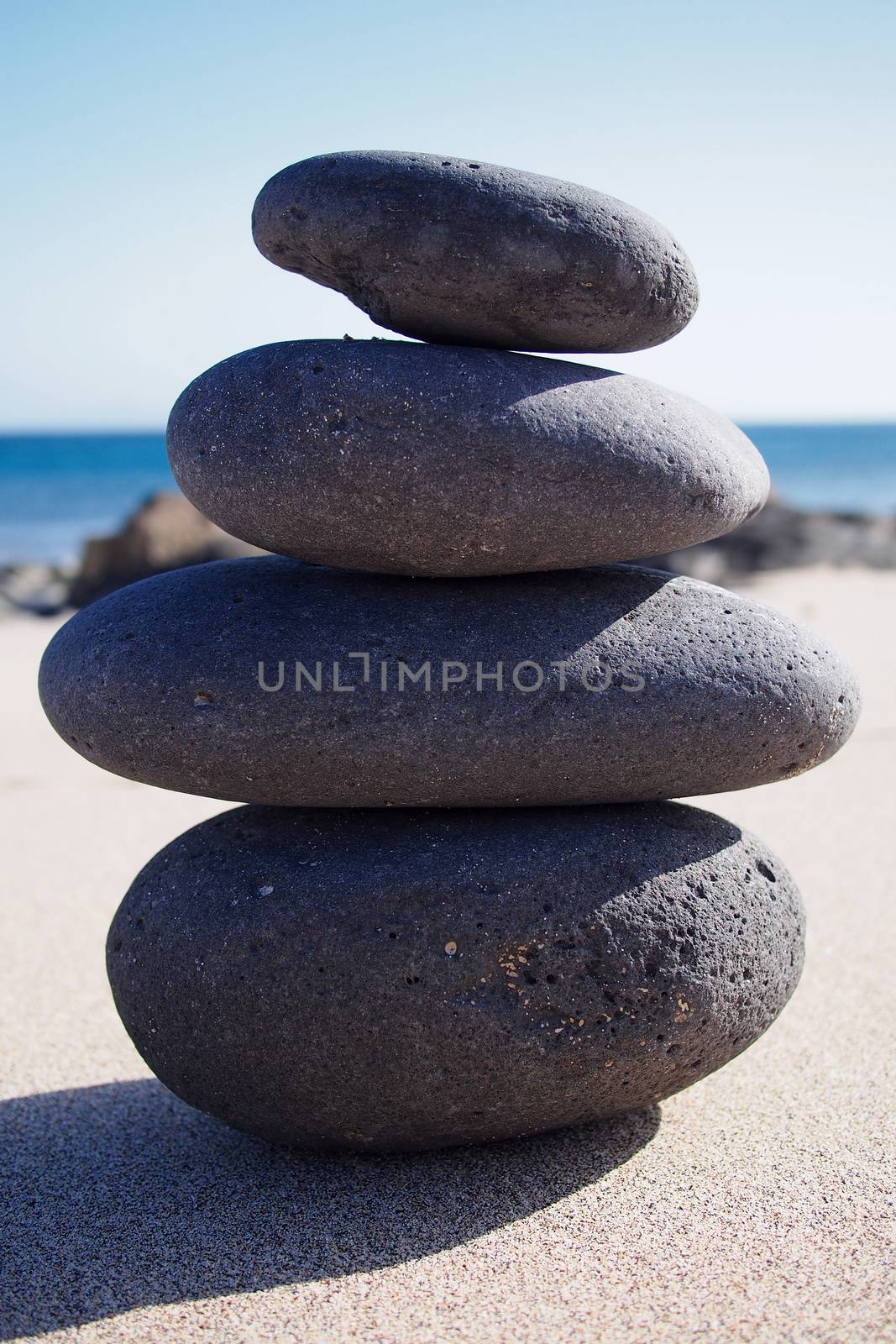 Zen-like stone pyramid on the beach by stockyimages