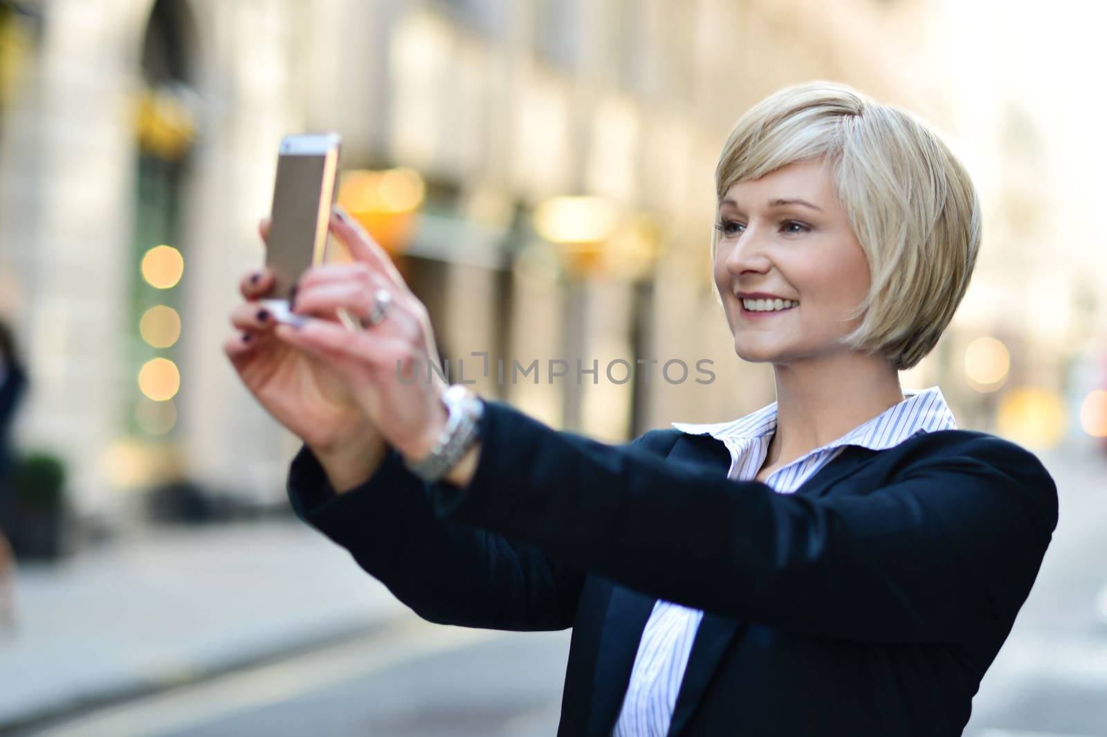 Corporate lady clicking her pic, outdoors