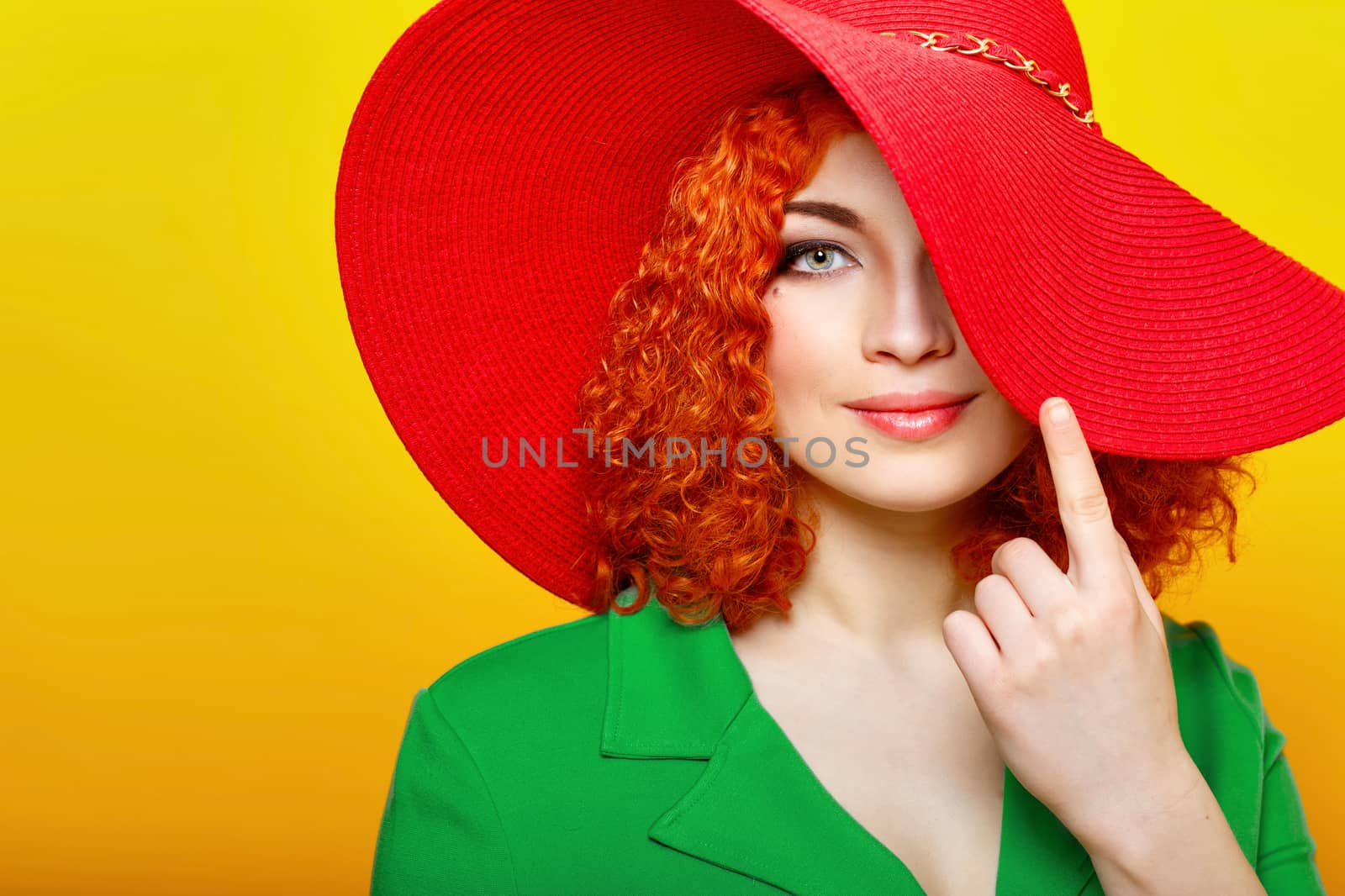 Attractive red-haired girl in red shady hat