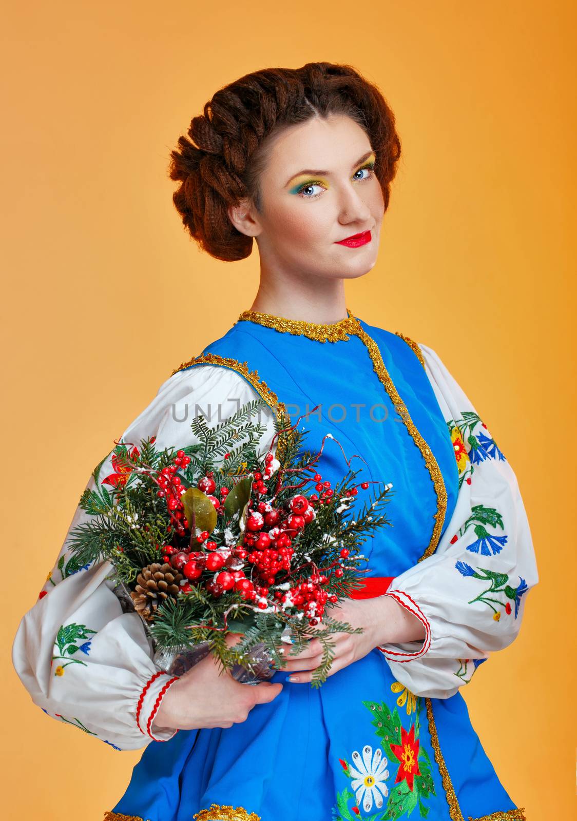 Girl holding flowers in her hands wearing national costume
