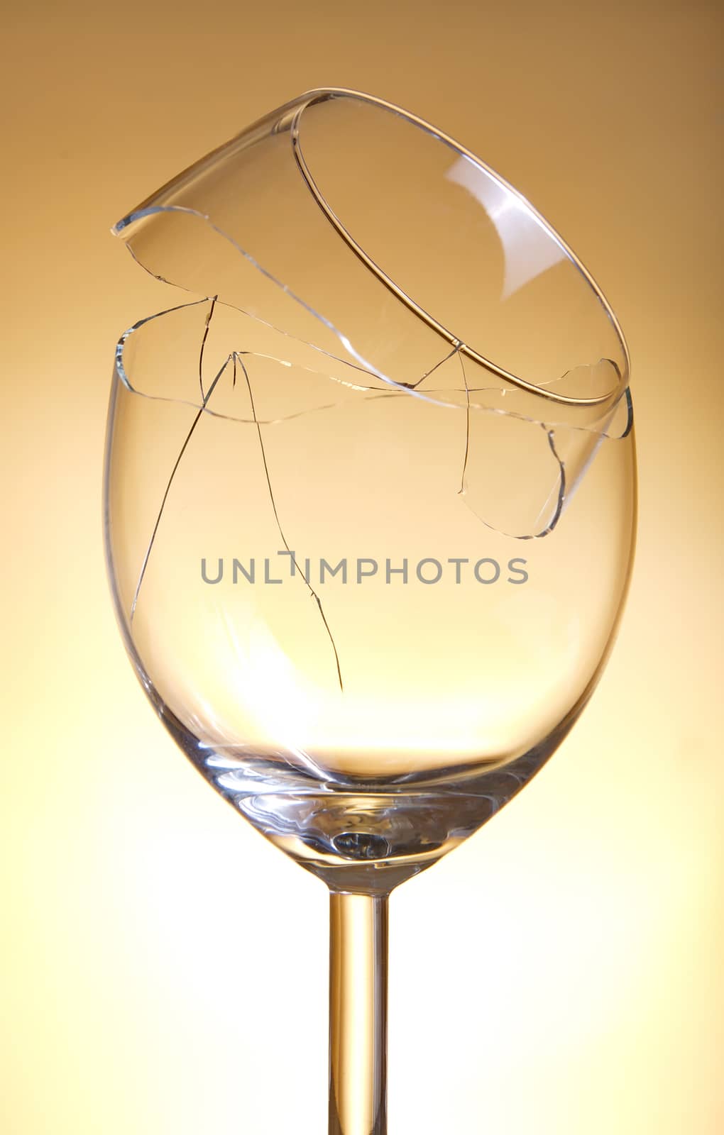 Broken vine glass on orange background by anderm