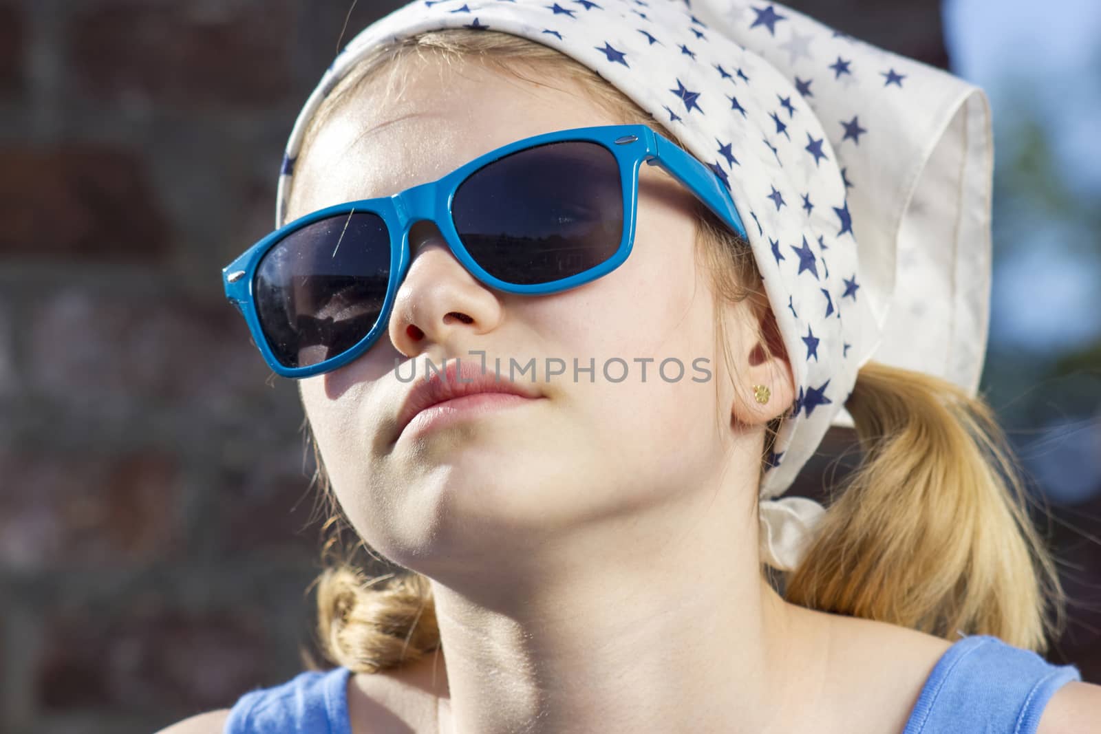 portrait of a cute little girl wearing sunglasses
