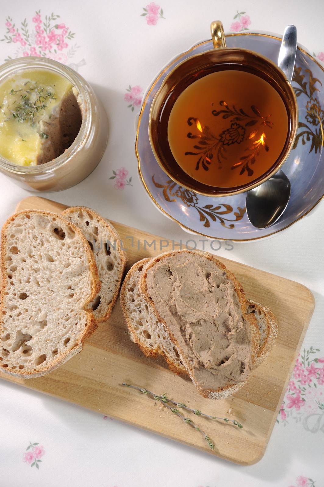 Chicken liver pate on bread and in jar by Apolonia