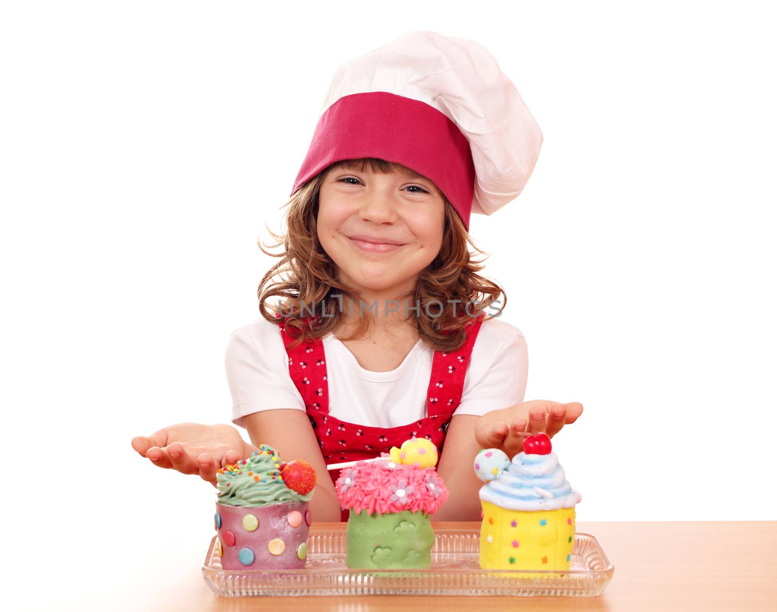 happy little girl cook with sweet cupcakes by goce