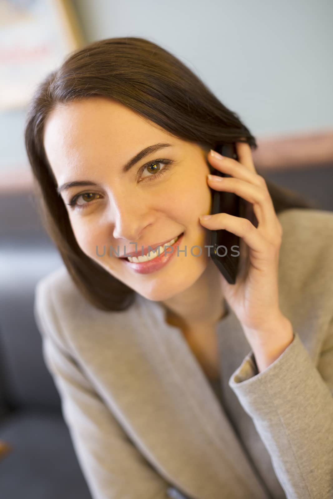 Pretty young woman on phone in coffee bar by LDProd