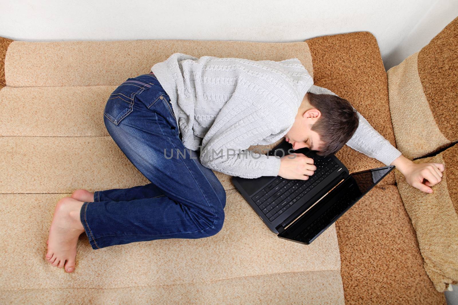 Teenager sleeps on Laptop by sabphoto