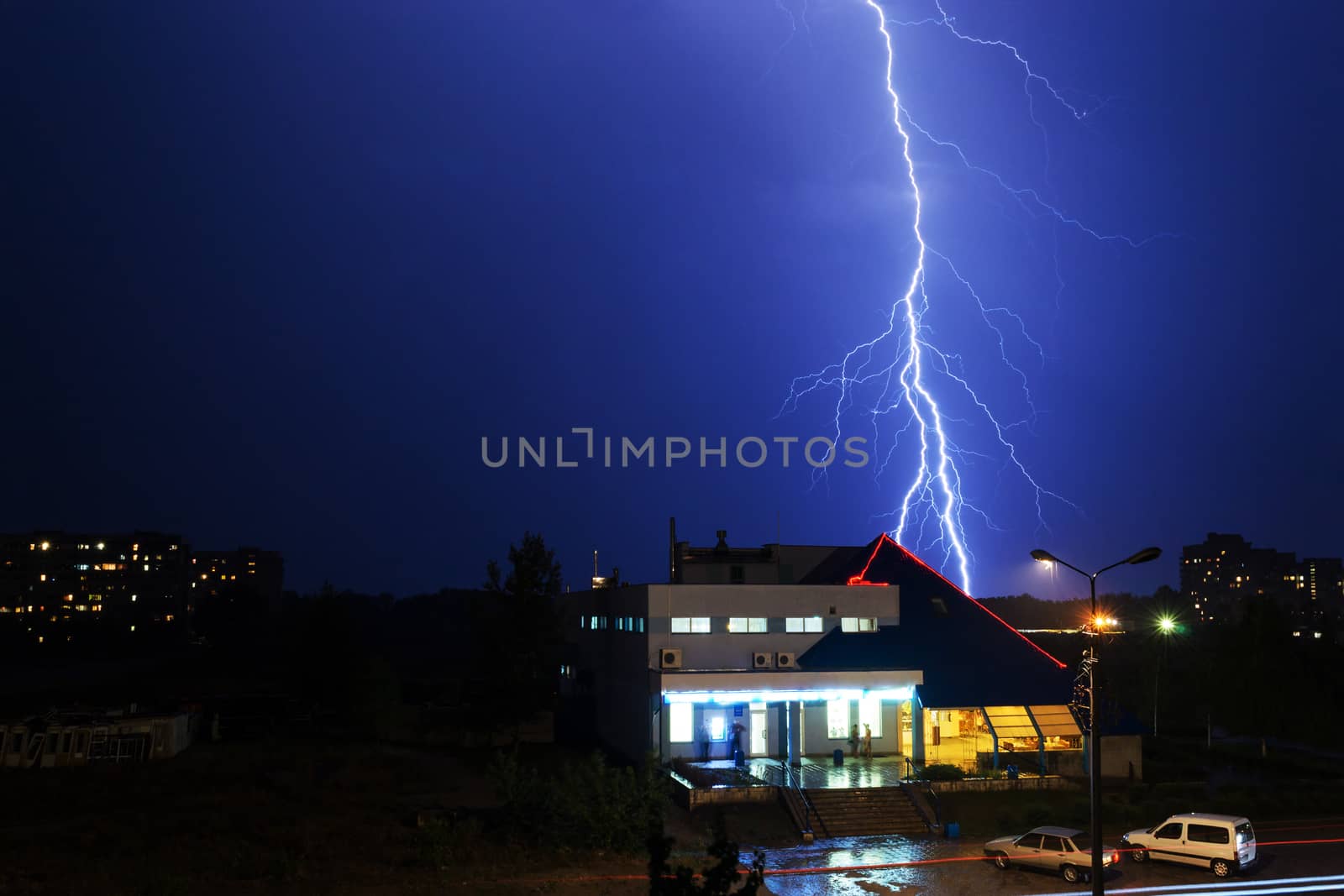 Severe lightning storm over a city buildings by s96serg