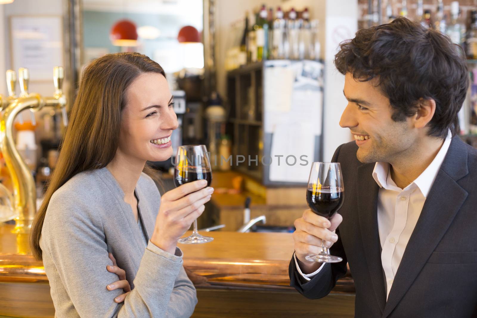 Loving couple takes a drink in restaurant by LDProd