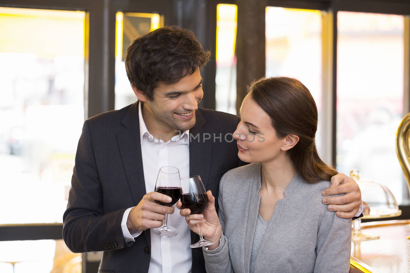 Loving couple takes a drink in restaurant by LDProd