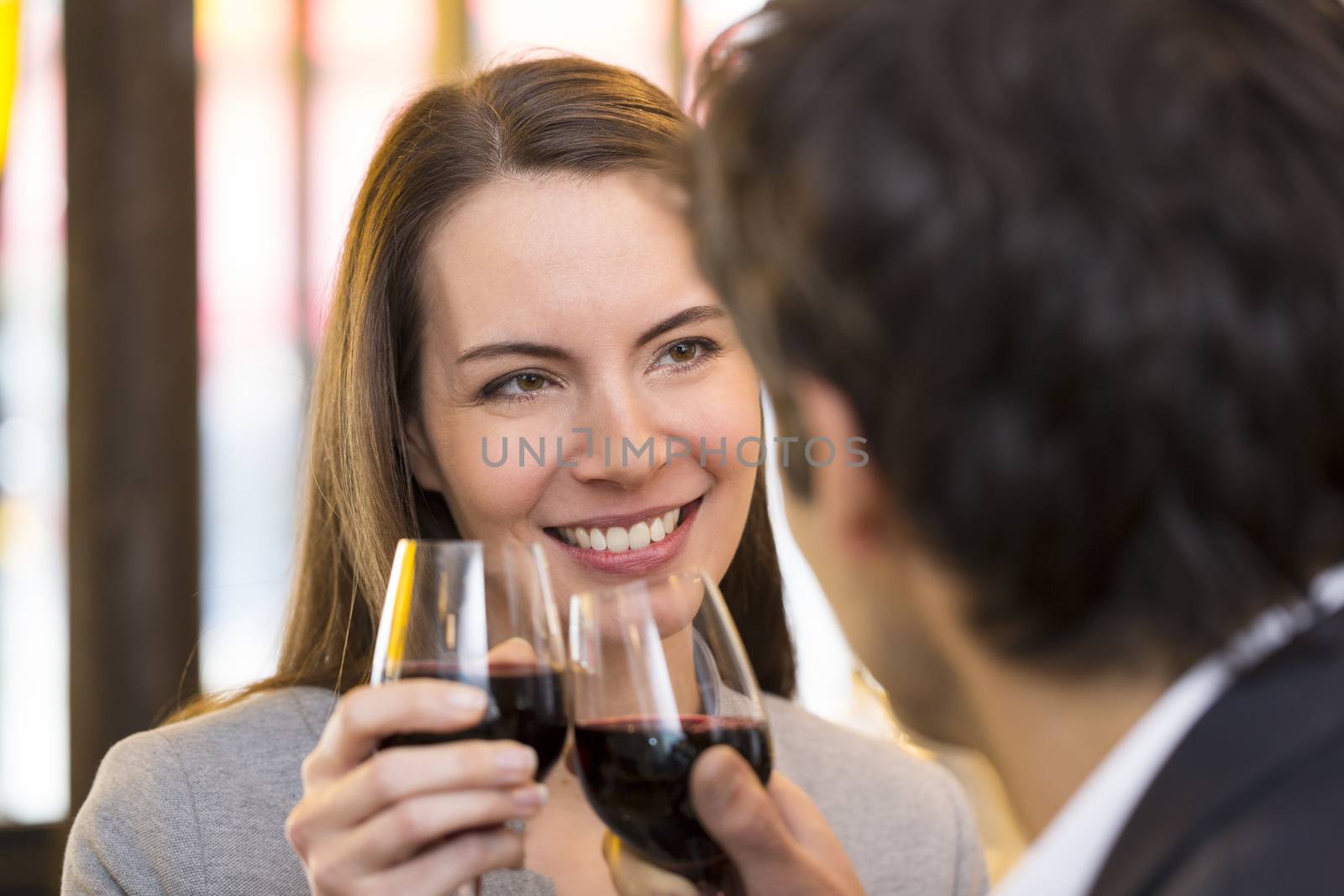 Loving couple takes a drink in restaurant by LDProd