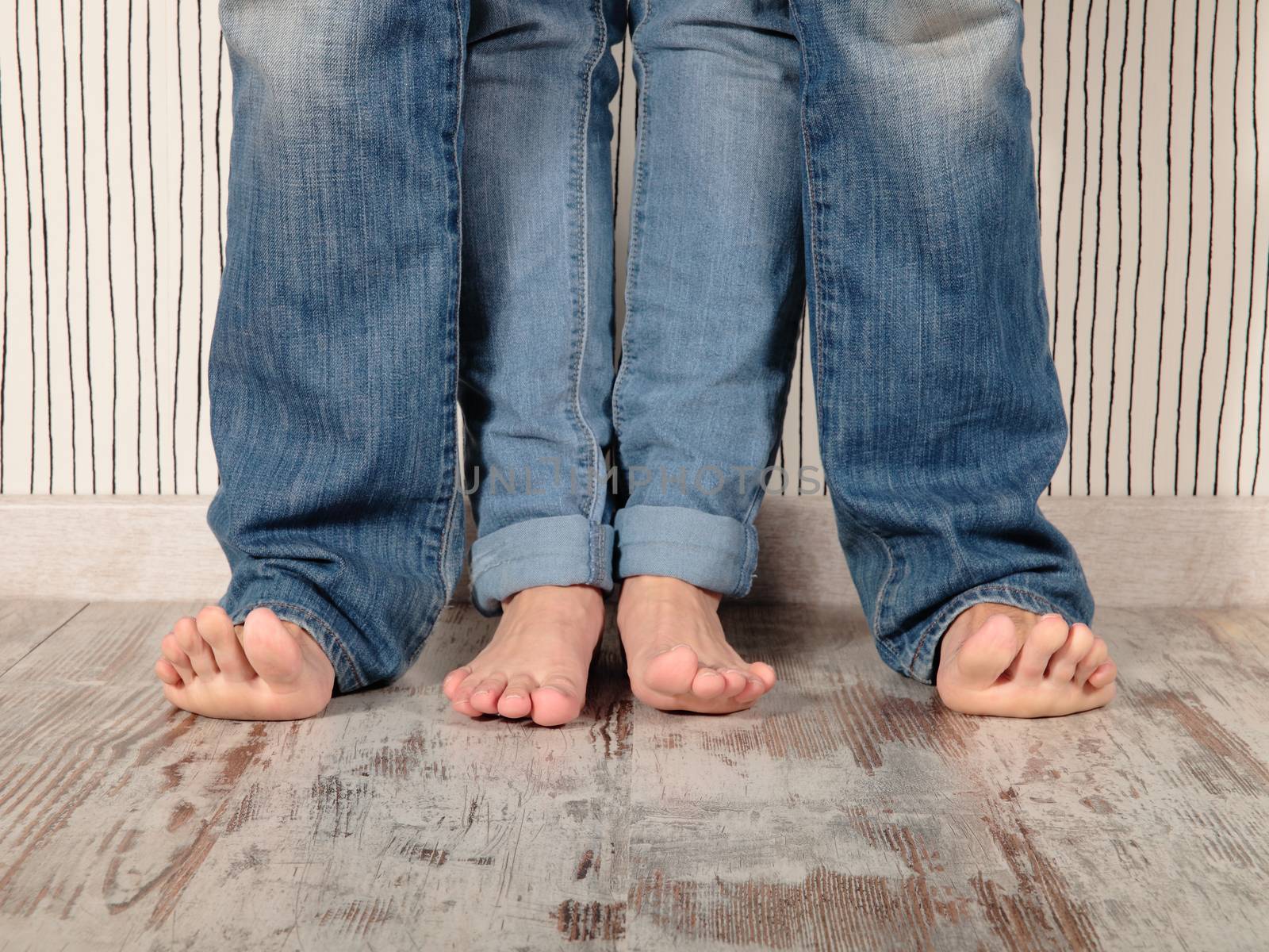 man and woman barefoot with jeans
