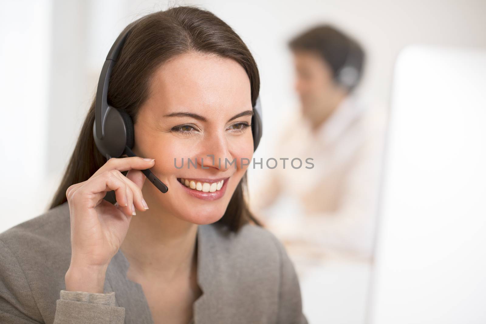 Helpline operator with computer in office, headset by LDProd