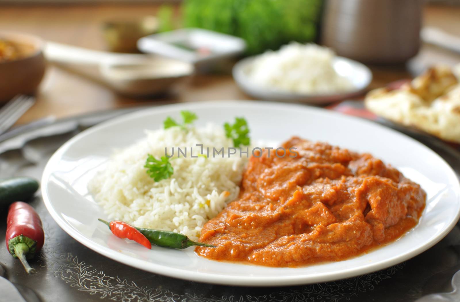 Chicken curry on a plate with rice an chilli pepper 