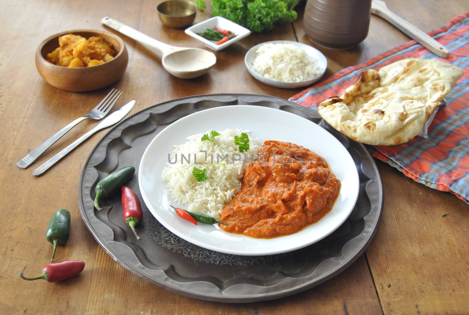 Chicken curry on a plate with rice an chilli pepper 