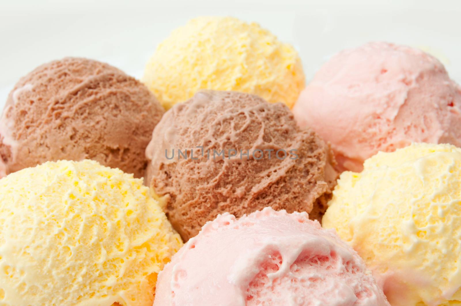 Icecream scoops with chocolate, vanilla and strawberry flavors 