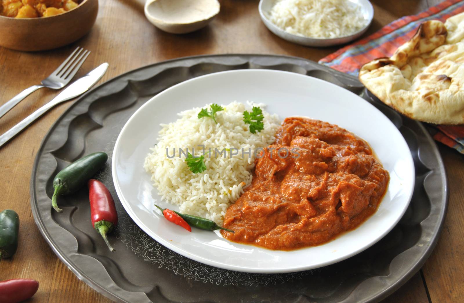 Chicken curry on a plate with rice an chilli pepper 