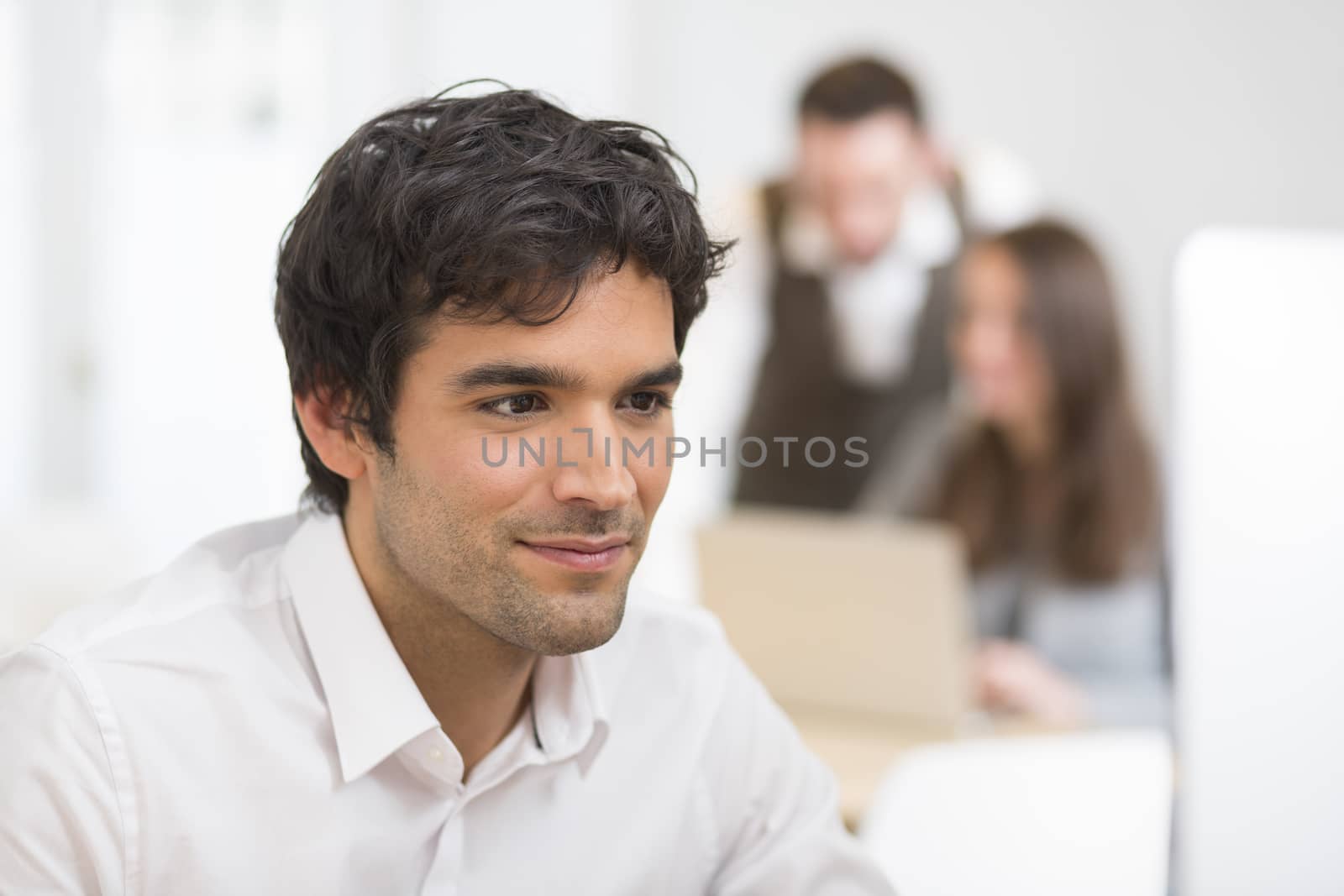 Portrait of businessman working on computer in office by LDProd
