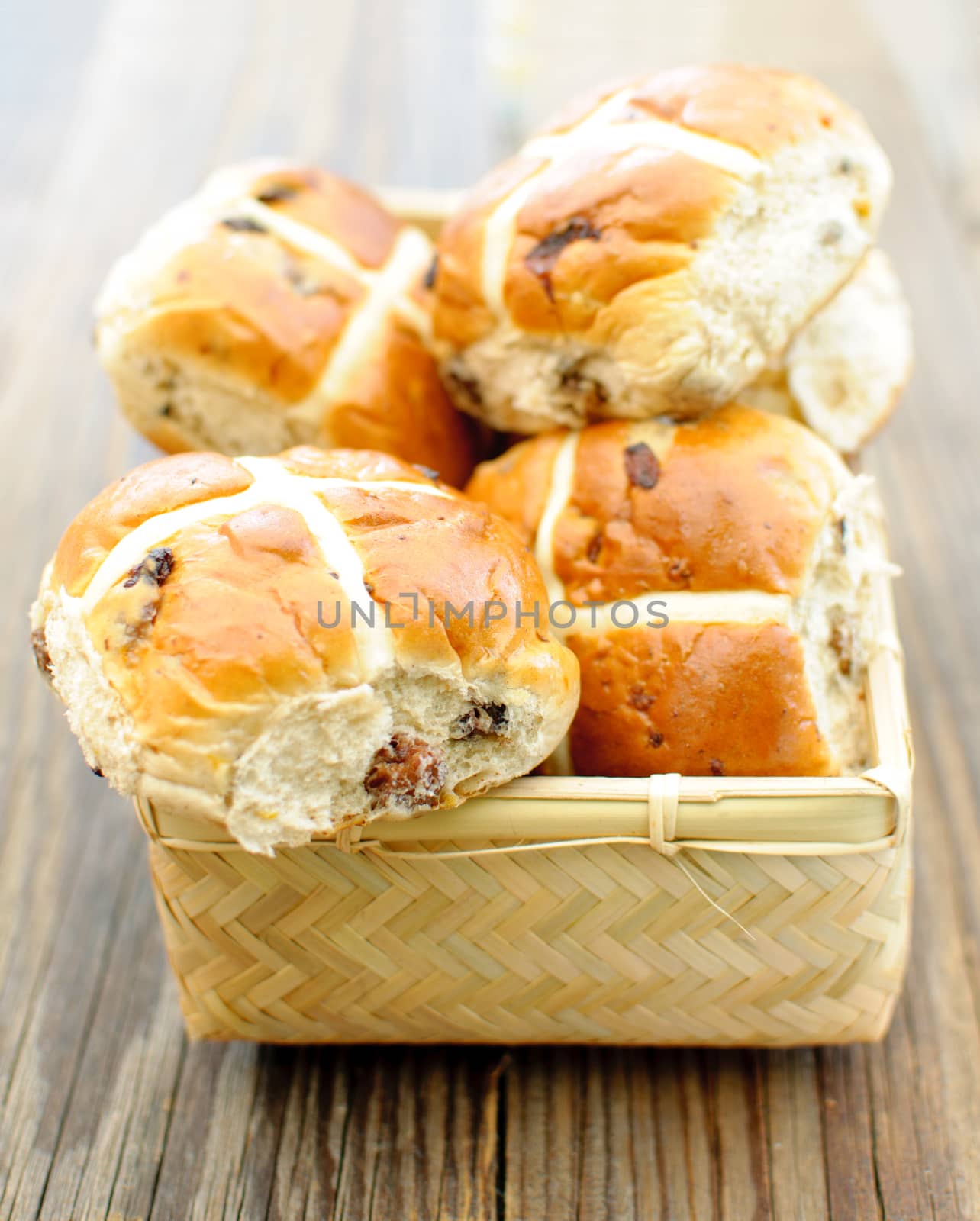 Freshly baked hot cross buns inside a basket 