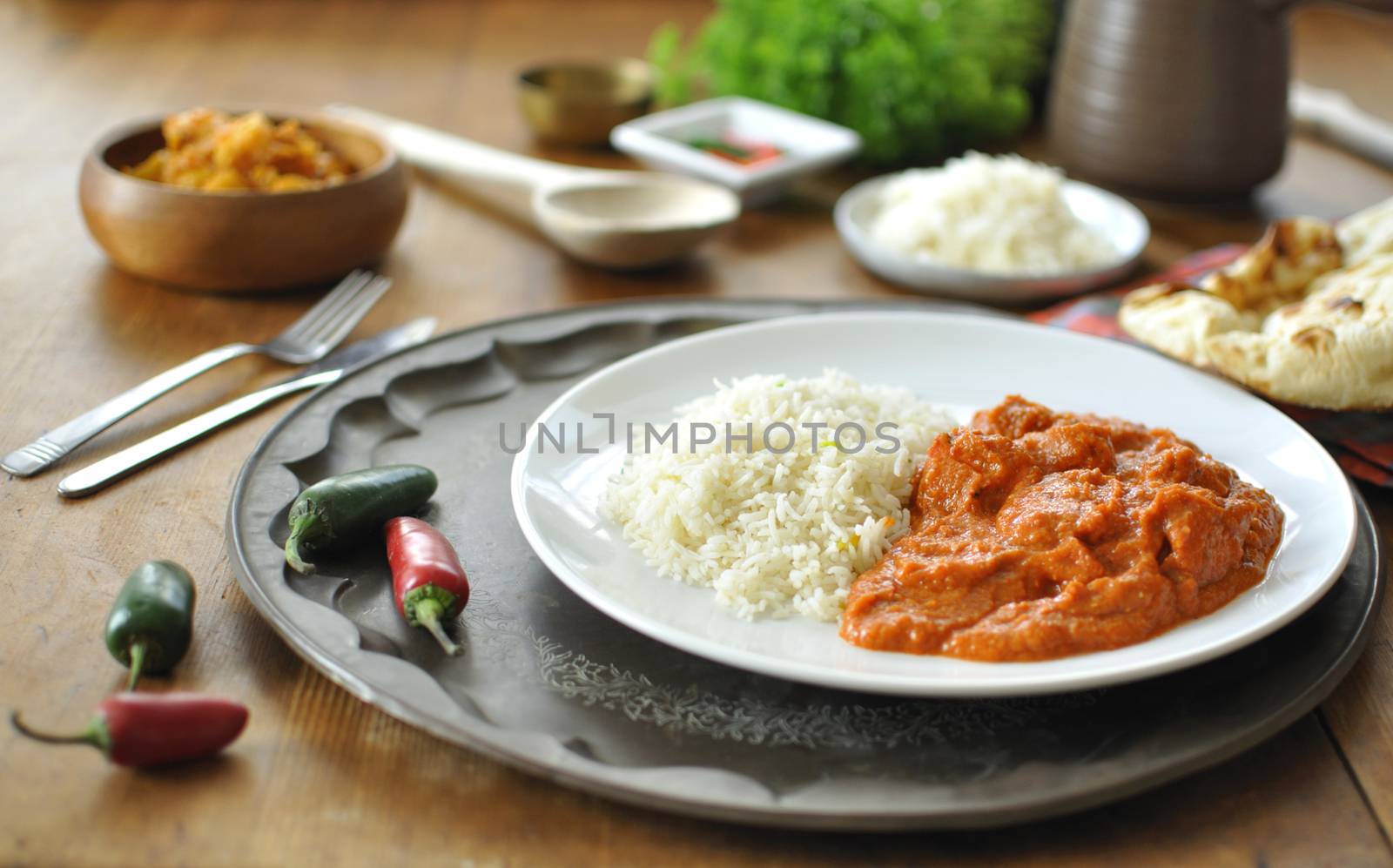 Chicken curry on a plate with rice an chilli pepper 