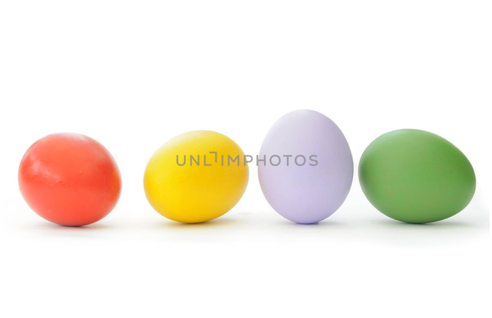 Painted easter eggs lined up in a row over a white background 